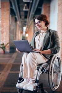 Photo of woman in wheelchair while using laptop
